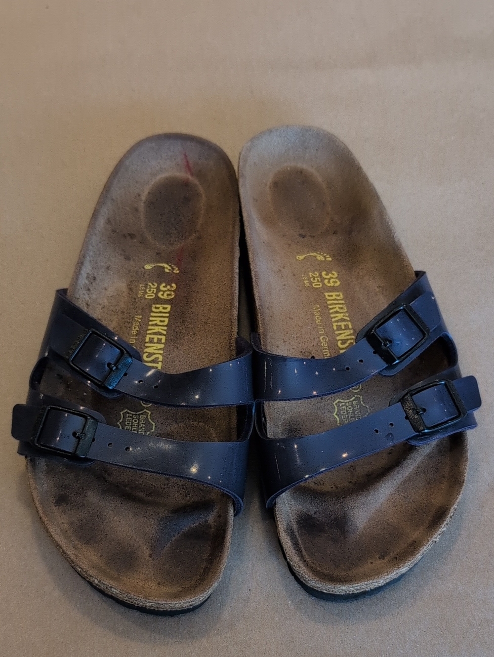 Birkenstock Ibiza double-strap sandals in a glossy violet-blue patent finish